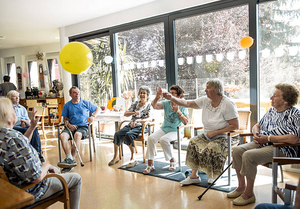 Seniors participating in Group Activities in Adult Daycare Center Seniors participating in Group Activities in Adult Daycare Center recreational pursuit stock pictures, royalty-free photos & images