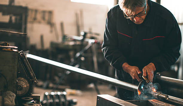 istock Welder welding metal in workshop with sparks 638888604