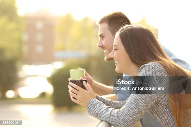 Happy Couple Enjoying Breakfast In A Balcony Stock Photo - Download Image Now - Balcony, Apartment, Couple - Relationship