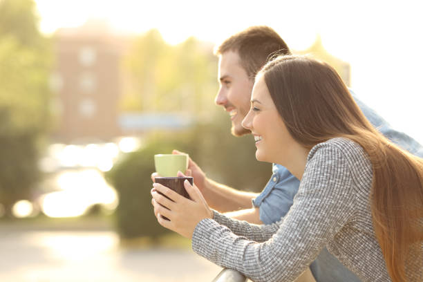 happy couple enjoying breakfast in a balcony - for rent sign house sign happiness imagens e fotografias de stock