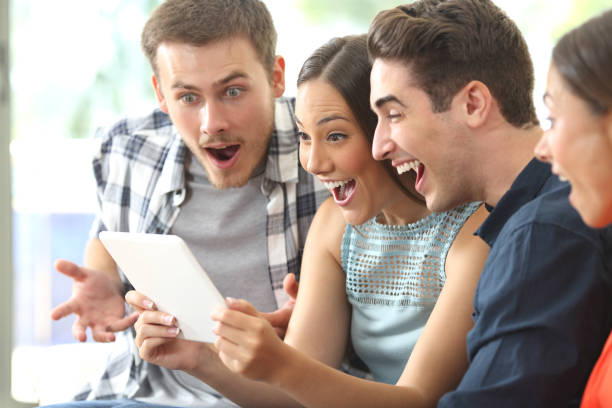 istock Amazed friends watching media in a tablet 638891284