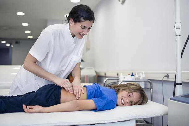 istock Happy nurse examining boy's back in hospital 638892094