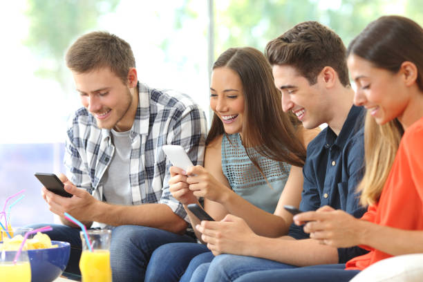 istock Happy friends using their mobile phones 638892098
