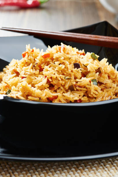 istock Close-up of Rice with vegetables on black square plate 638892330