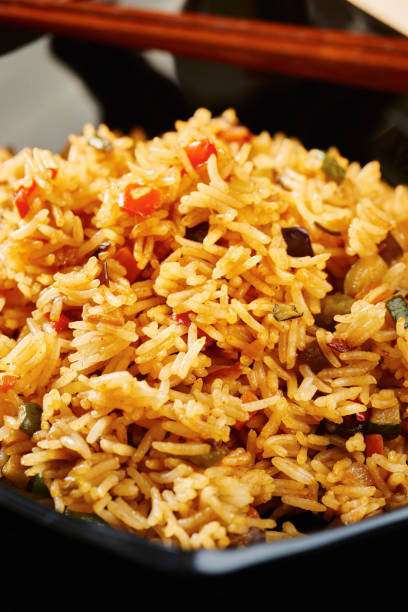 istock Close-up of Rice with vegetables on black square plate 638892630