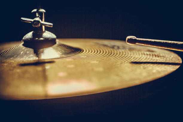Close up shot of a drumstick hitting a cymbal.