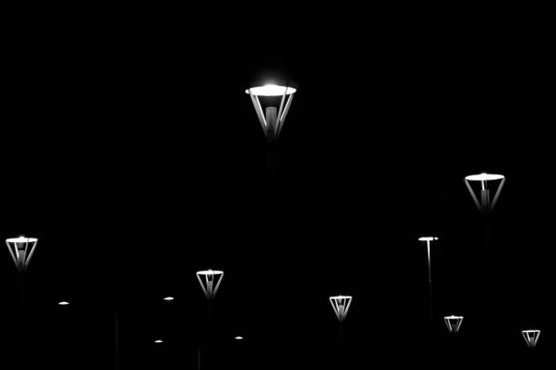 At night, street lamps on parking lot look like space ships.
