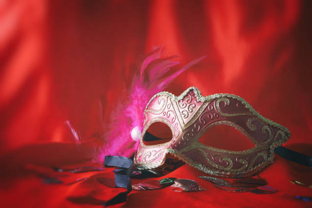istock elegant venetian mask on red silk background 638895158