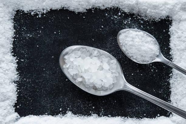 istock Sea salt grains frame on the black background. 638895268