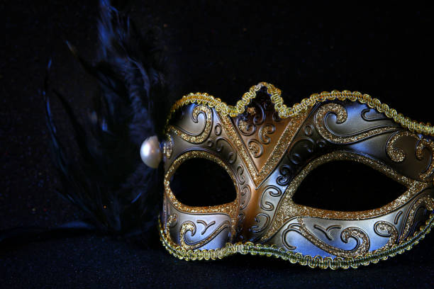 istock black venetian mask on glitter background 638895900