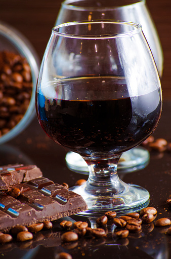 rum and chocolate in a glass on a dark background