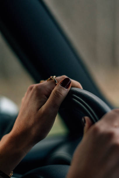 istock Young woman driving a car 638898564