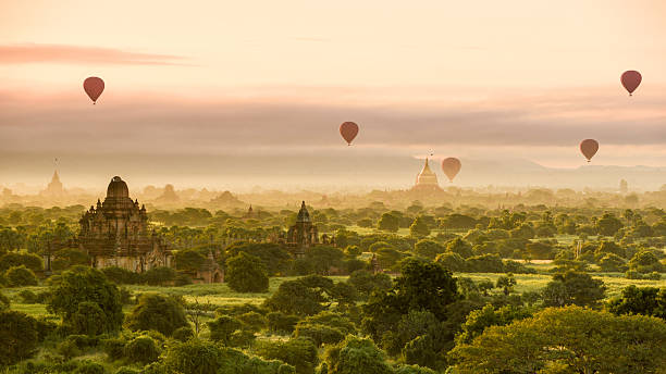 Morning at Bagan with hot air balloons Hot air balloons dot the morning sky in Bagan, Myanmar bagan archaeological zone stock pictures, royalty-free photos & images