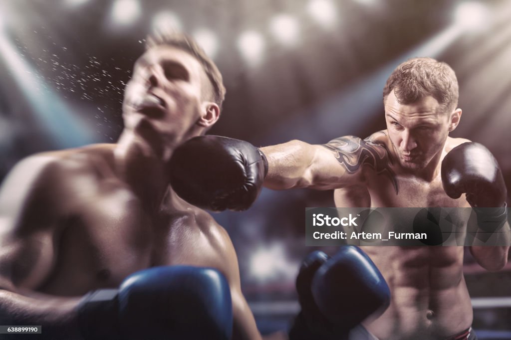 Fighting Two professional boxers fighting in the ring Boxing - Sport Stock Photo