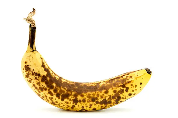 Very ripe banana on a white background