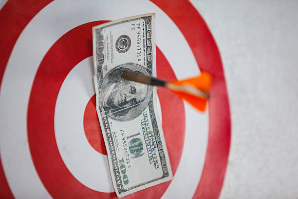 istock Darted hundred dollars on dart board 638901198