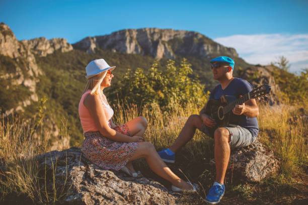 istock Young Couple in a Park playing guitar 638901210