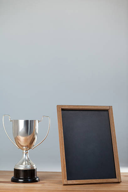 istock Trophy and chalkboard on wooden table 638901240