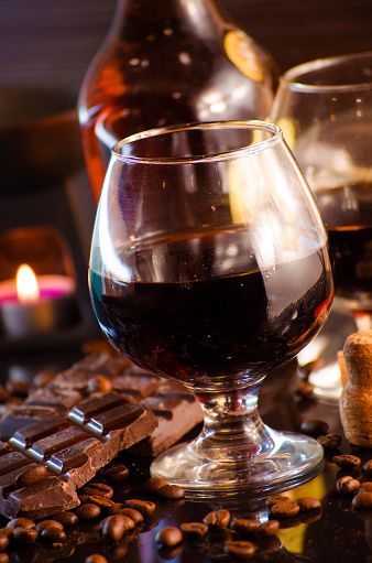 rum and chocolate in a glass on a dark background