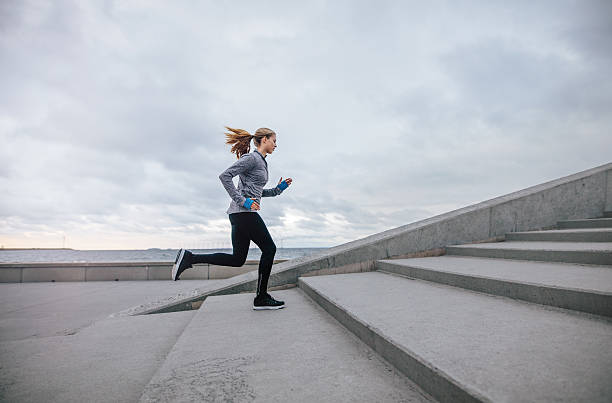 istock Fitness woman running up on steps 638901558