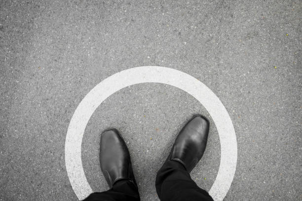 istock Black shoes standing in white circle 638902044