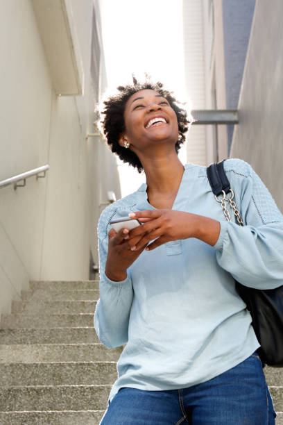 istock Smiling young african lady walking down the steps 638902046