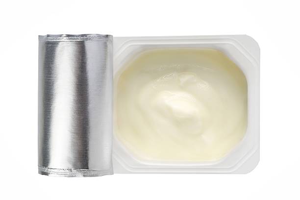 istock Yogurt in white plastic pot from above on white background 638902158
