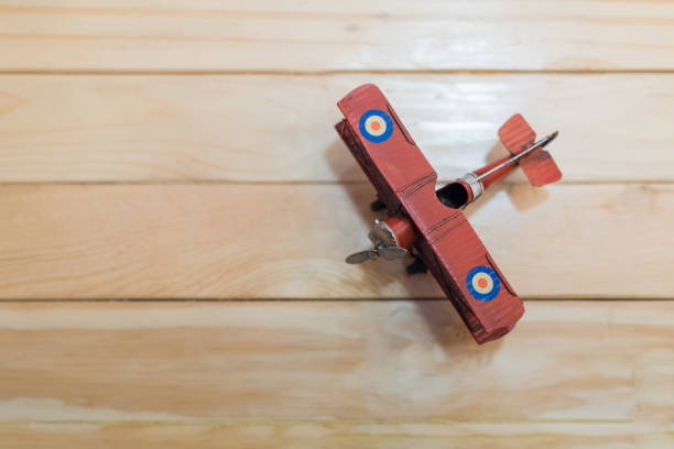 istock Old Red airplane model on wooden table. 638902800