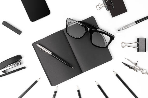 istock Blank notepad with clips, pens and glasses flat lay. 638903048