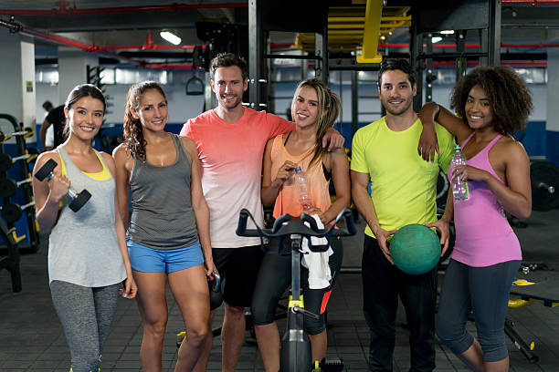 Group of happy Latin American people at the gym looking at the camera - healthy lifestyle