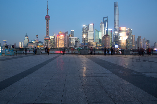 The modern district of Pudong skyline, as seen from the Huangpu river banks on the Bund.