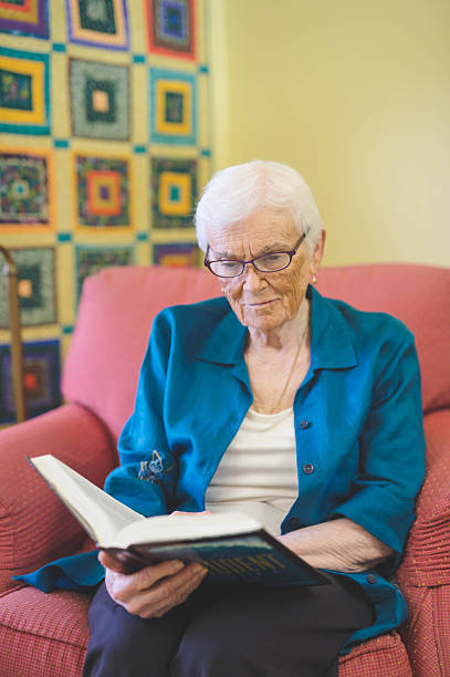 istock An elderly woman reading a book in a care facility 638903738