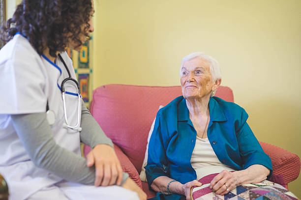istock Young ethnic nurse talking with elderly woman in facility 638903756