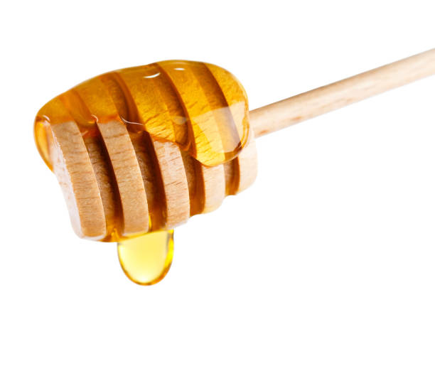 istock Honey dripping from a honey dipper. 638903880