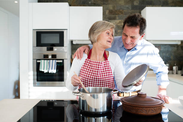 istock Senior couple in the kitchen cooking together. 638909814