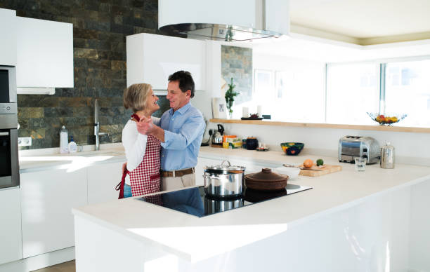 istock Senior couple in the kitchen cooking and dancing together. 638910014