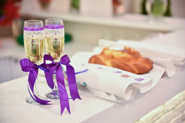 wedding glasses with sparkling wine and purple ribbons.