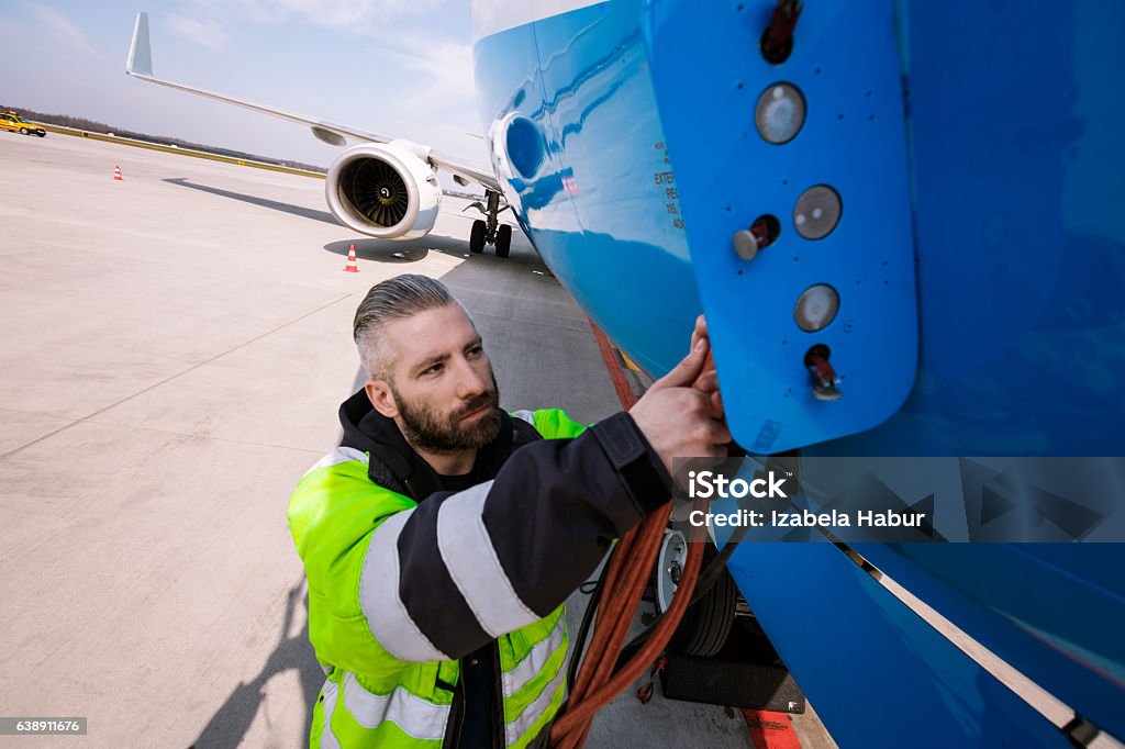 Airport worker Airport worker chcecking aircraft. Ground Crew Stock Photo