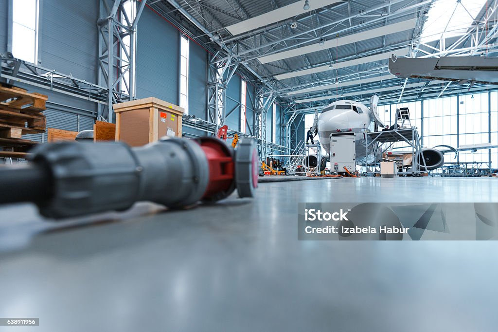 Hangar, low angle view Low angle view of hangar, aircraft in the background. Airplane Hangar Stock Photo