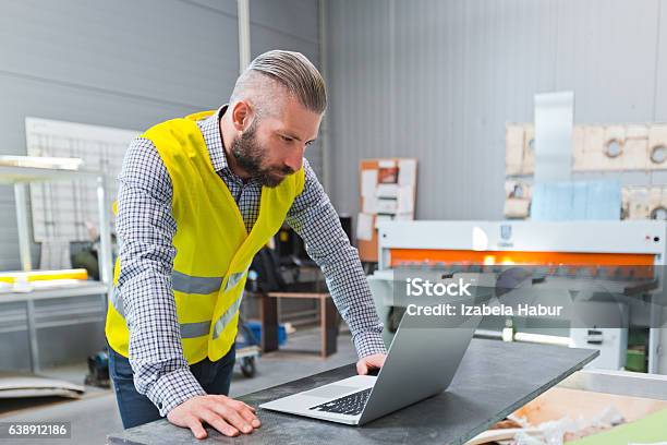 Engineer Using A Laptop At Work Stock Photo - Download Image Now - Adult, Beard, Business
