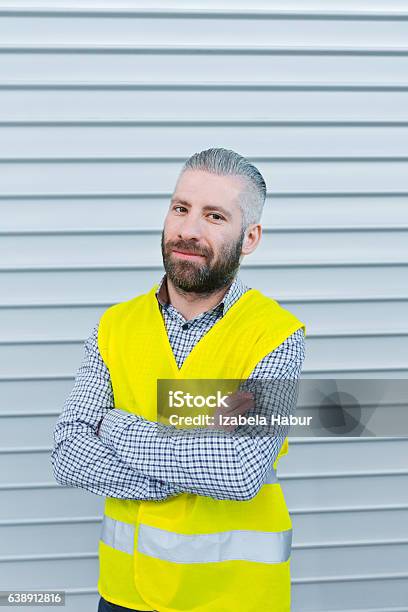 Smiling Engineer In Front Of Metal Door Stock Photo - Download Image Now - Adult, Adults Only, Beard