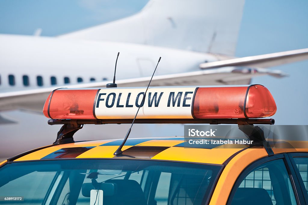 Follow me car at the airport Airport Stock Photo