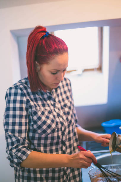 istock happy woman cooking on kitchen 638913250