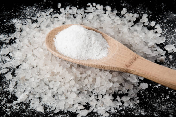 istock Sea salt grains on the black background. 638914690