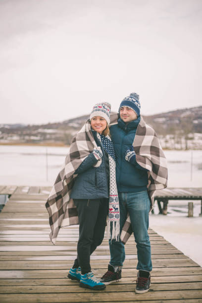 istock Couples holding each other on the shore of lake 638915464