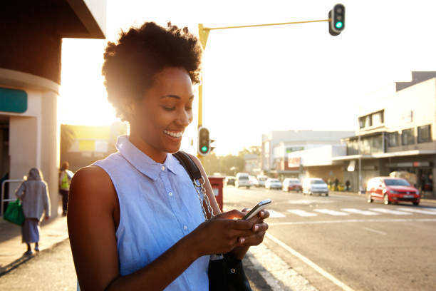 istock Beautiful african woman using cellphone outdoors 638917436