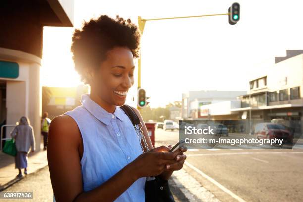Beautiful African Woman Using Cellphone Outdoors Stock Photo - Download Image Now - Women, African Ethnicity, One Woman Only