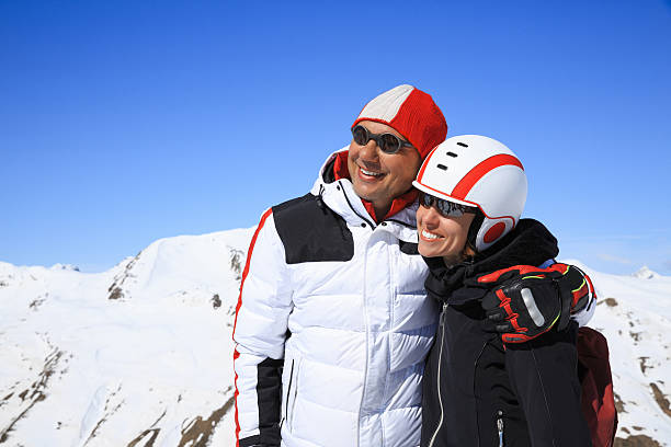 winter couple  men and women snow skiers enjoying resting - pair couple mid adult happiness imagens e fotografias de stock