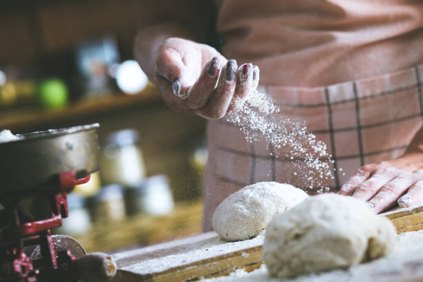 istock Close up of female baker hands kneading dough 638920674