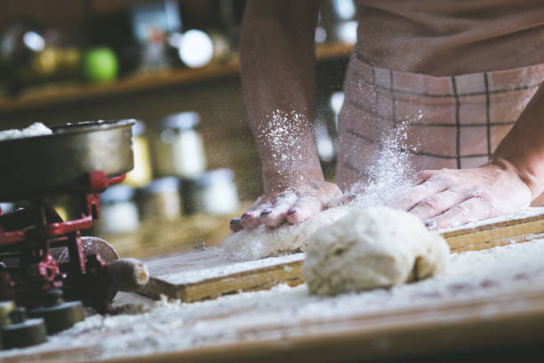istock Close up of female baker hands kneading dough 638920810